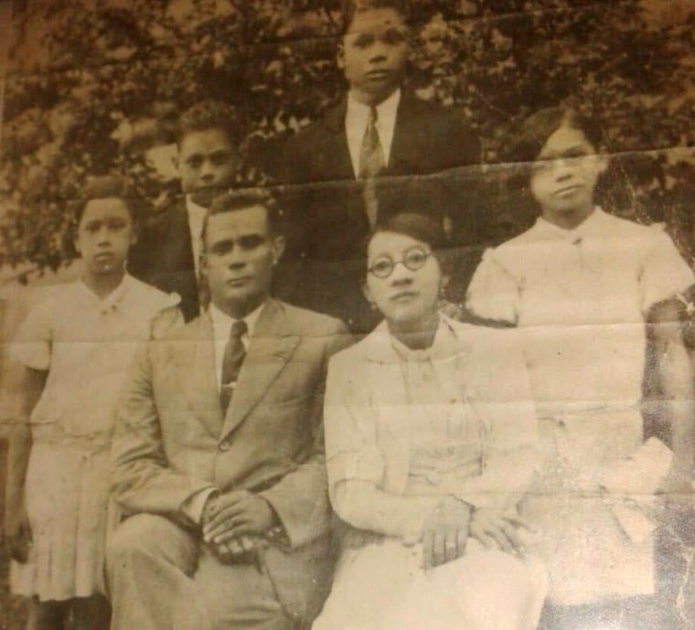 Panama Canal worker John Miller stands with his wife and their four children. 