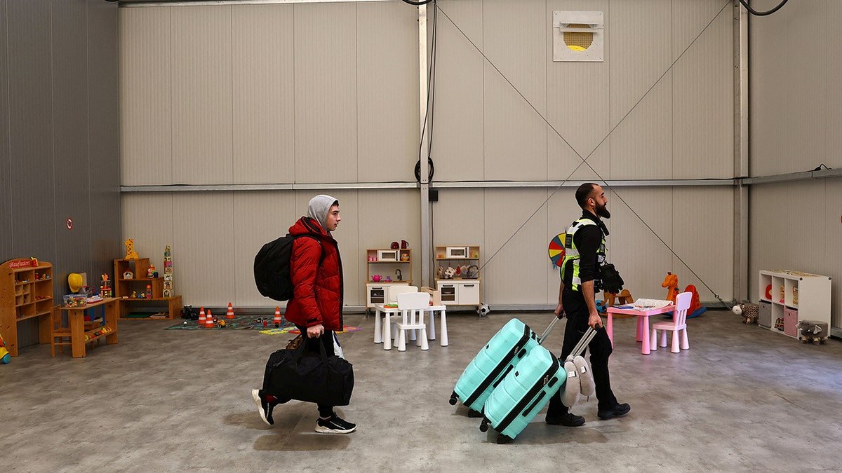 Ukrainian refugees arrive at a temporary shelter in Hanau