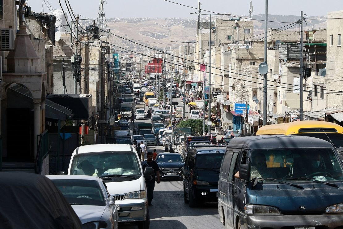 Cars drive along a road in the Palestinian refugee camp of Baqa near Amman, Jordan, in May 2024.