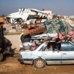 Gazans Crowd the Road North, Joyful but Anxious