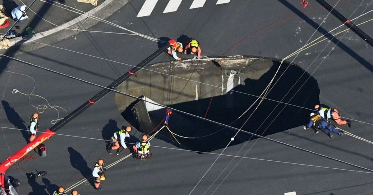 Swimming pool-sized sinkhole swallows truck in Japan, trapping driver inside