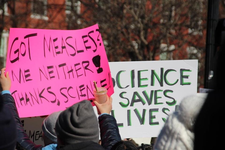 Reading the protest indicators, & quot; Got the measles? Neither me Thanks, science! & quot; And & & quot; Science saves life. & quot;