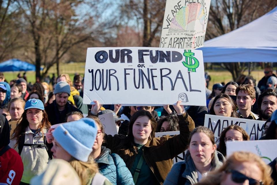 Demonstrators indicators, a reading & quot; Gathered with our funds or your funeral, & quot; Advocating for climate action in a public park sequence