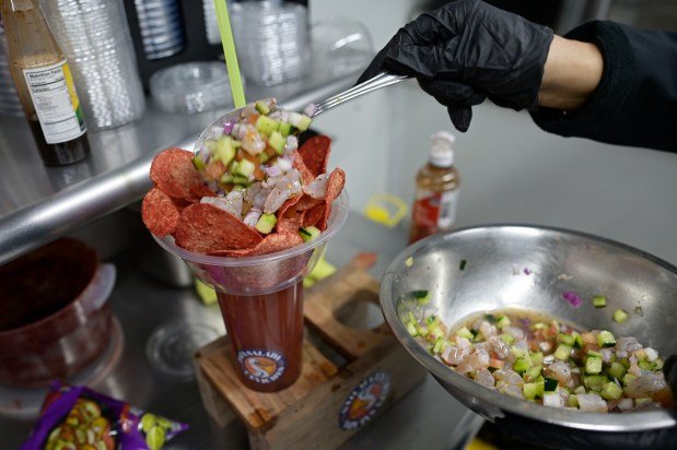 Patessi Egular produces a dish on his leash salada Sews Food truck in La Plaza Colorado in Aurora, Colorado, on Friday, March 7, 2025.