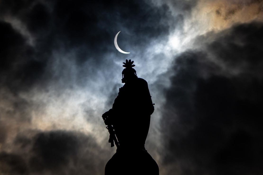 The partial solar moon eclipse is seen on April 8, on the Capital Hill in Washington DC, on the statue of the American Capital Building Dome. 