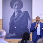 Michael Curry, President of the Massachusetts League of Community Health Centers speaks during a community meeting to work towards a dedicated Health and Wellness Center for Hyde Park.