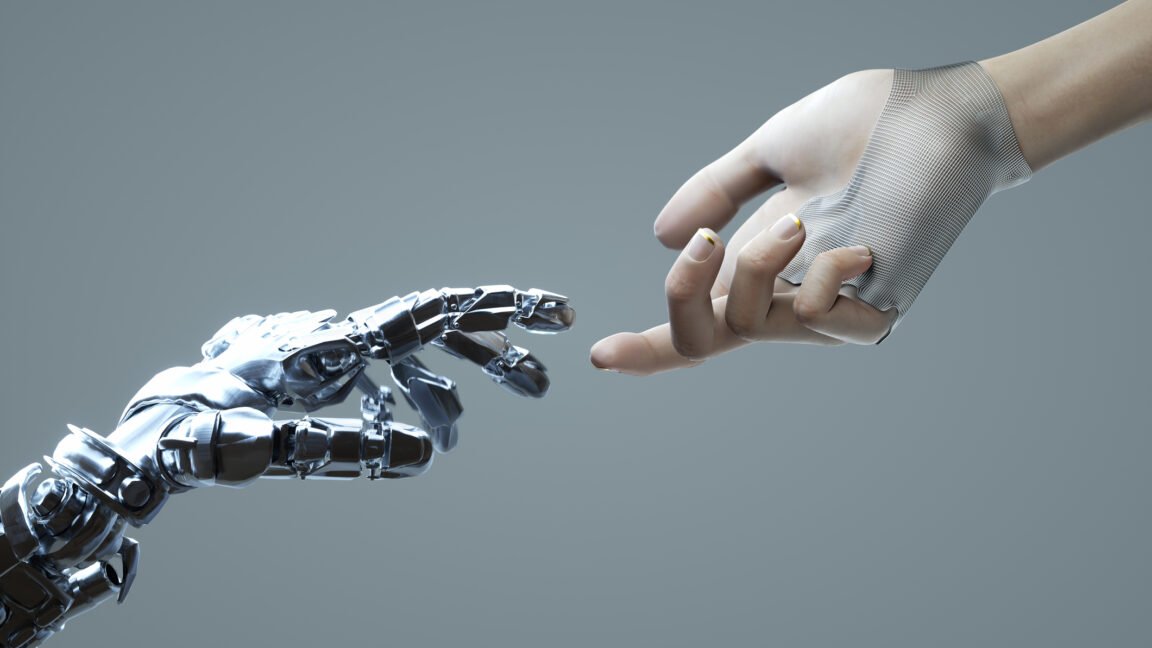 Digital image of a robotic and a human hand touching a finger against a grey backdrop.