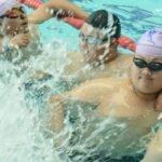 Obese young Chinese students play in a swimming pool