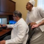 Dr. Sivakumar Ardhanari, cardiologist, ECU Health, and Maxine Shepherd, nurse, ECU Health, treat a patient from Edenton, North Carolina, virtually.