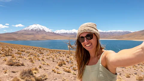 Getty Images Poses for selfie in front of a female passenger mountain and lake (Credit: Getty Images))