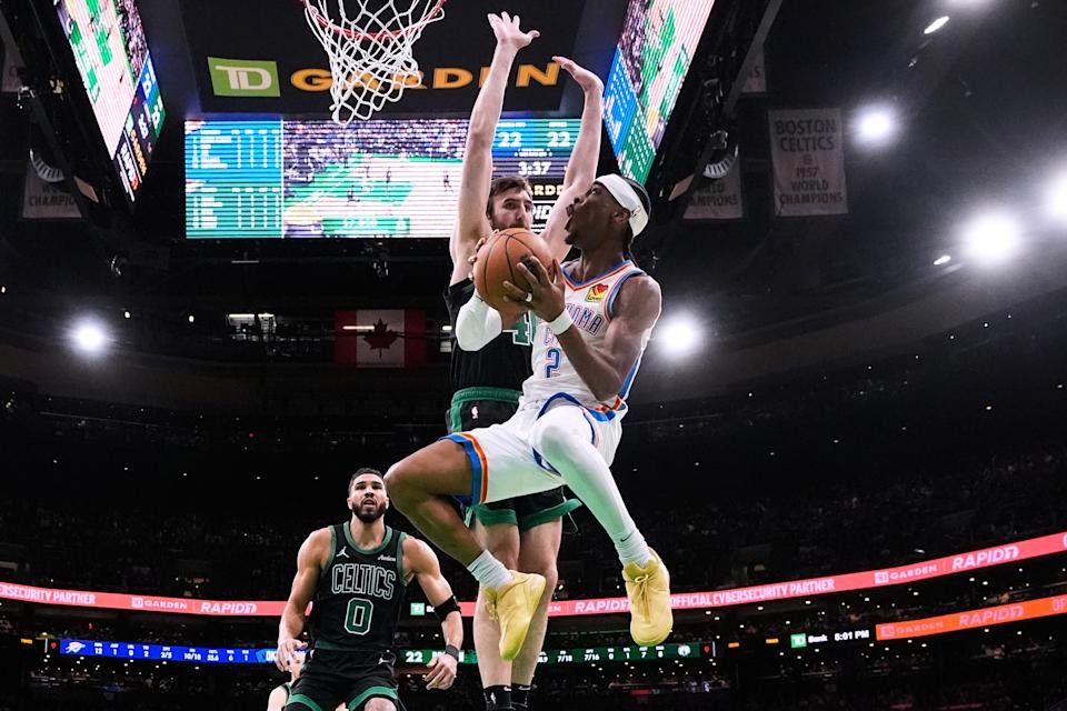 Oklahoma City Thunder Guard Shai Guljis Alexander (2) Boston on Wednesday, March 12, 2025, during the first half of the NBA basketball game, Boston Selts Center Luke Cornet, Rear Right, and Forward Jason Tatum (0). (AP Photo/Charles Krapa)