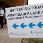 An Affordable Care Act application and enrollment help sign outside of a building.